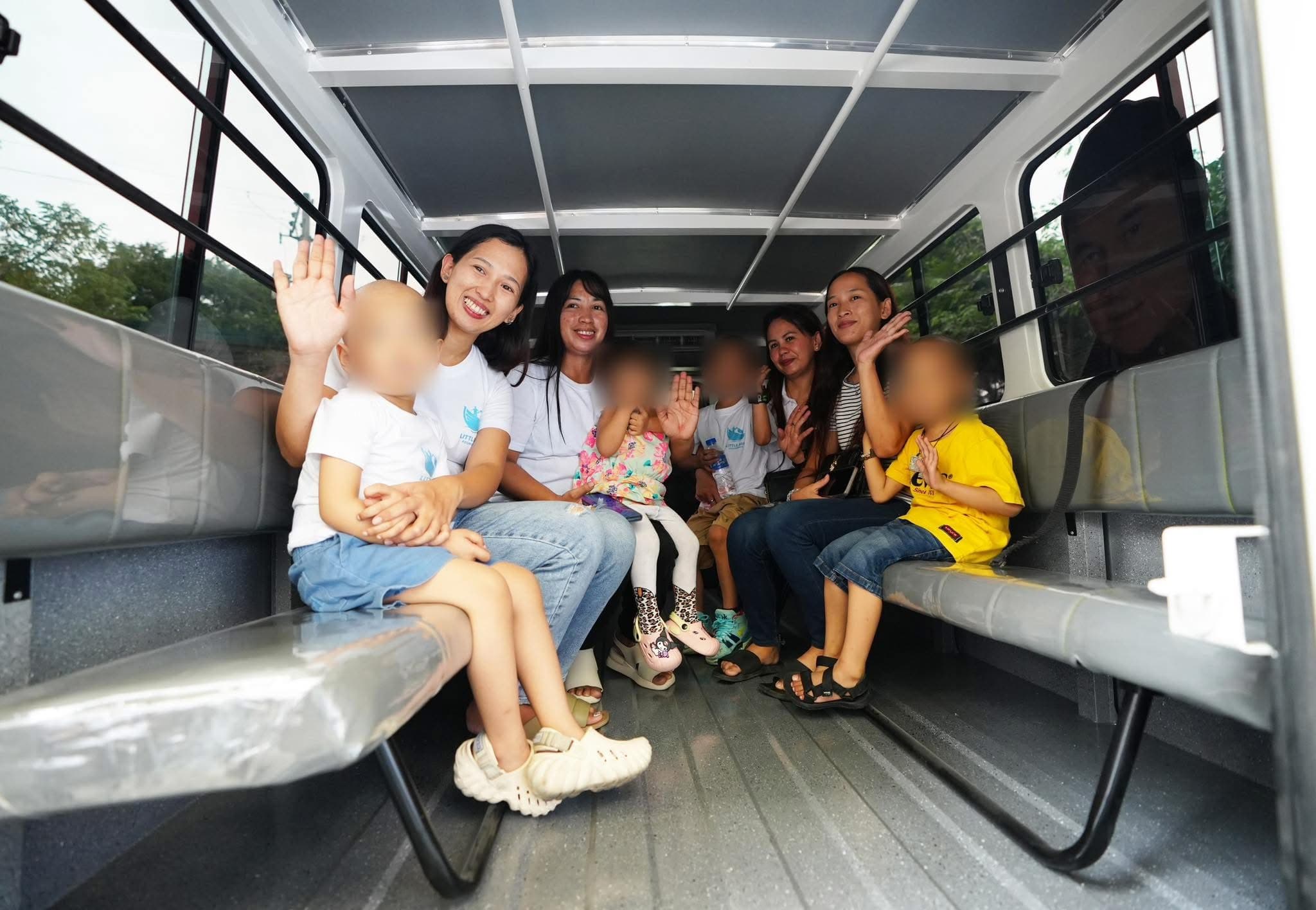 Children, caregivers, and Little Ark team members riding in the Hope in Transit shuttle