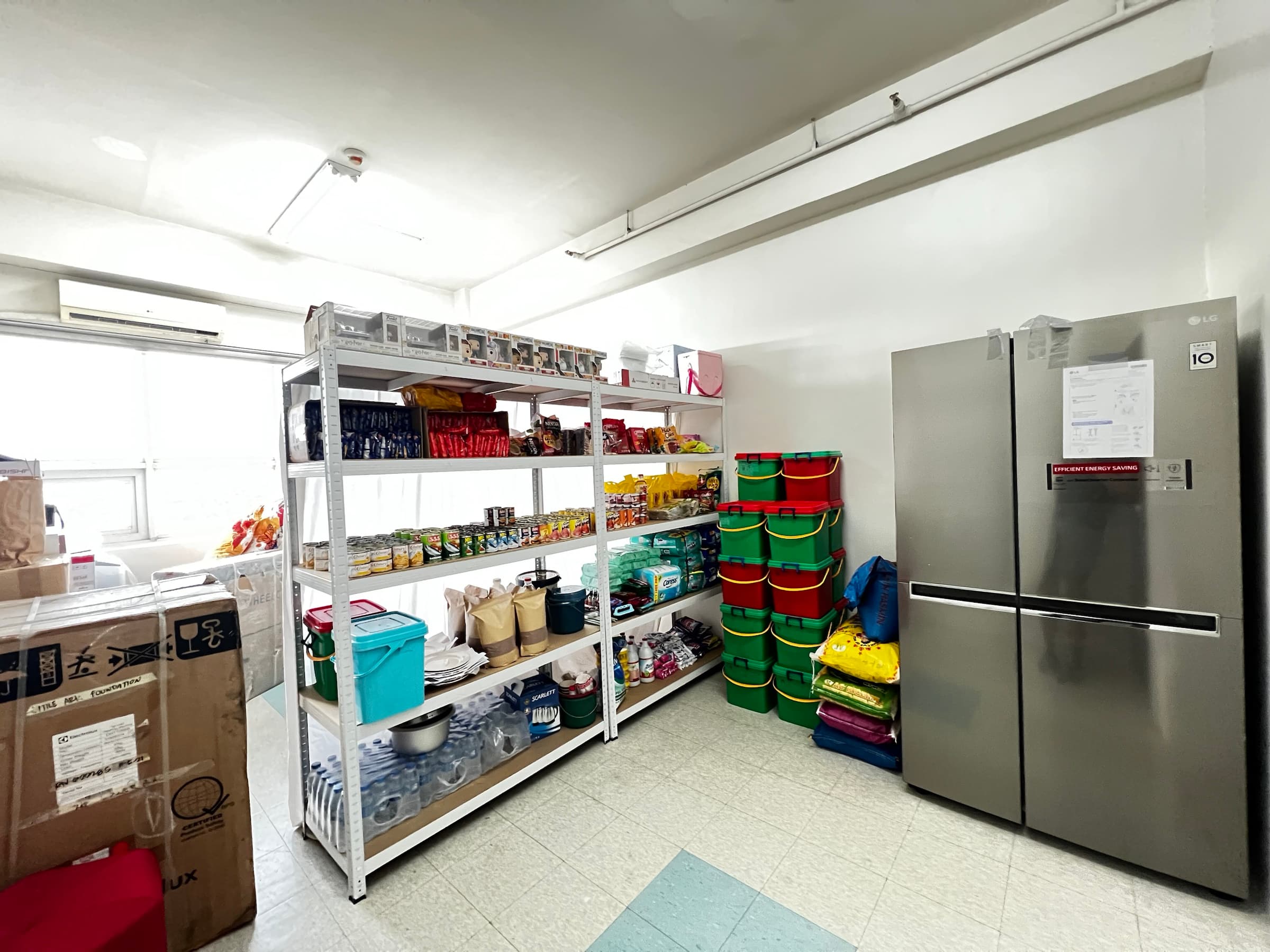 Food, household supplies, and storage shelves inside the larger condo unit