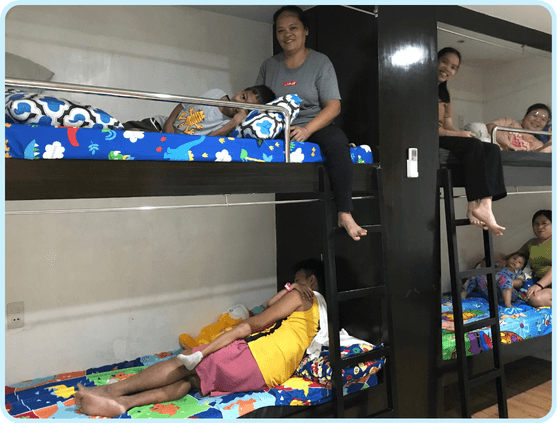 Children and caregivers resting in Little Ark temporary housing