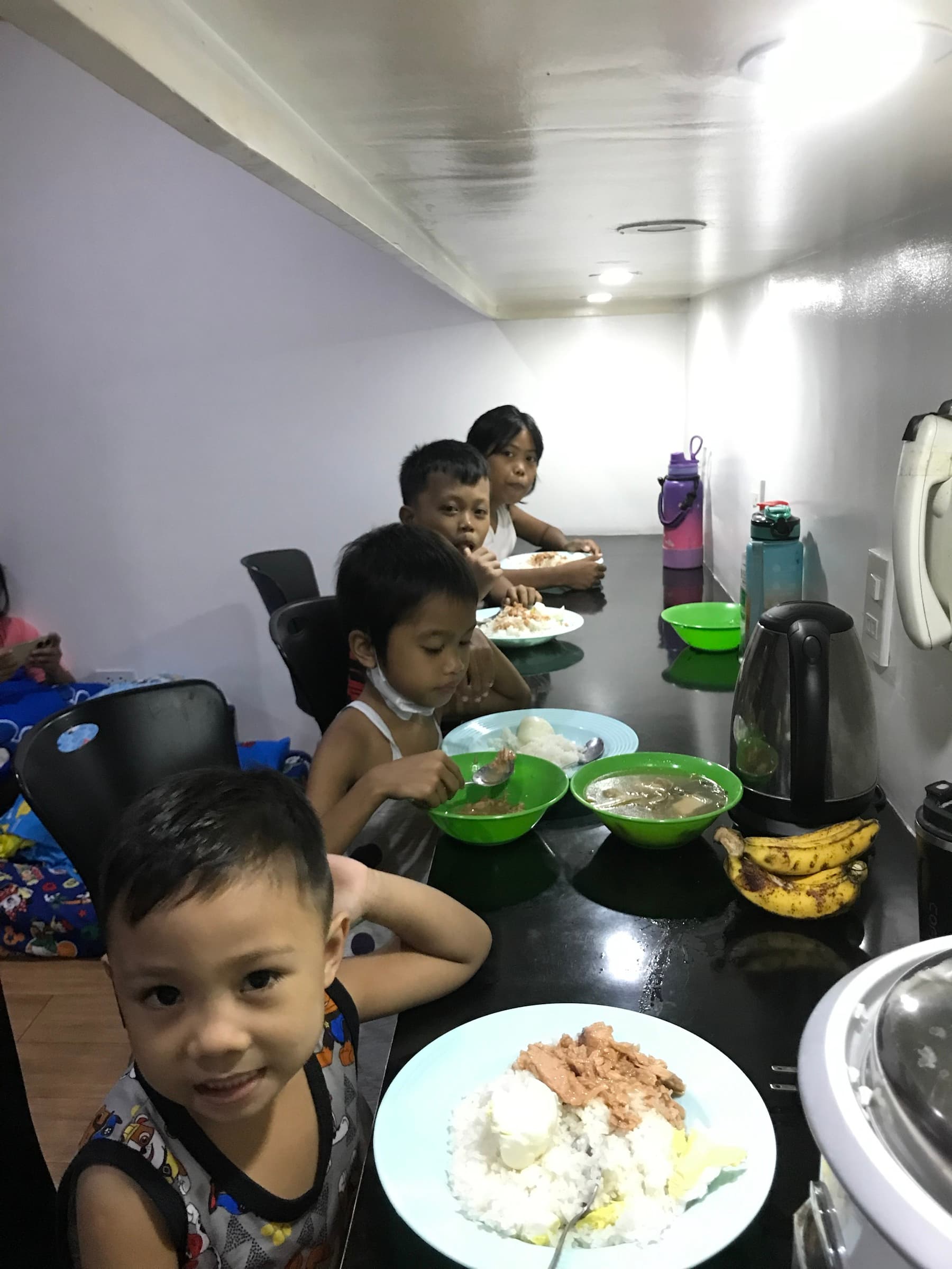 Children sharing a meal during their stay with Little Ark Foundation