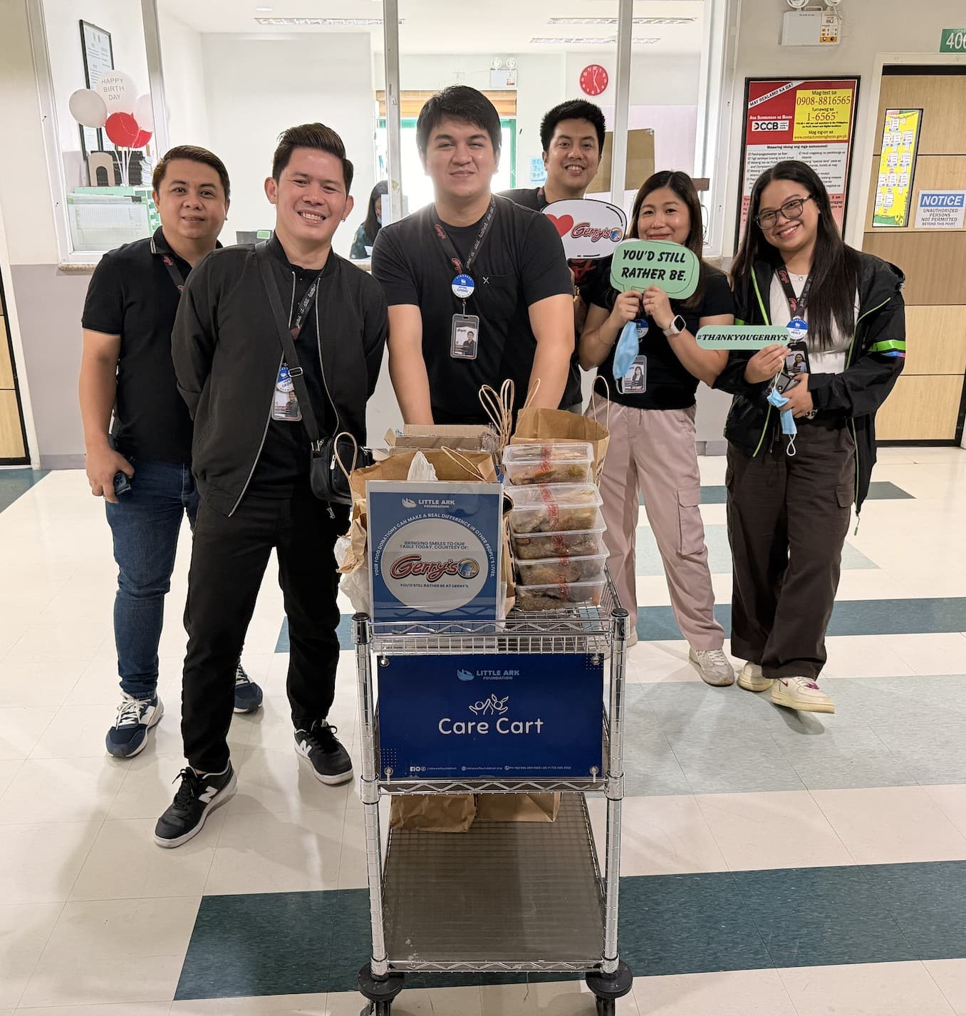 Care Cart supporters gathered behind the cart with meal donations