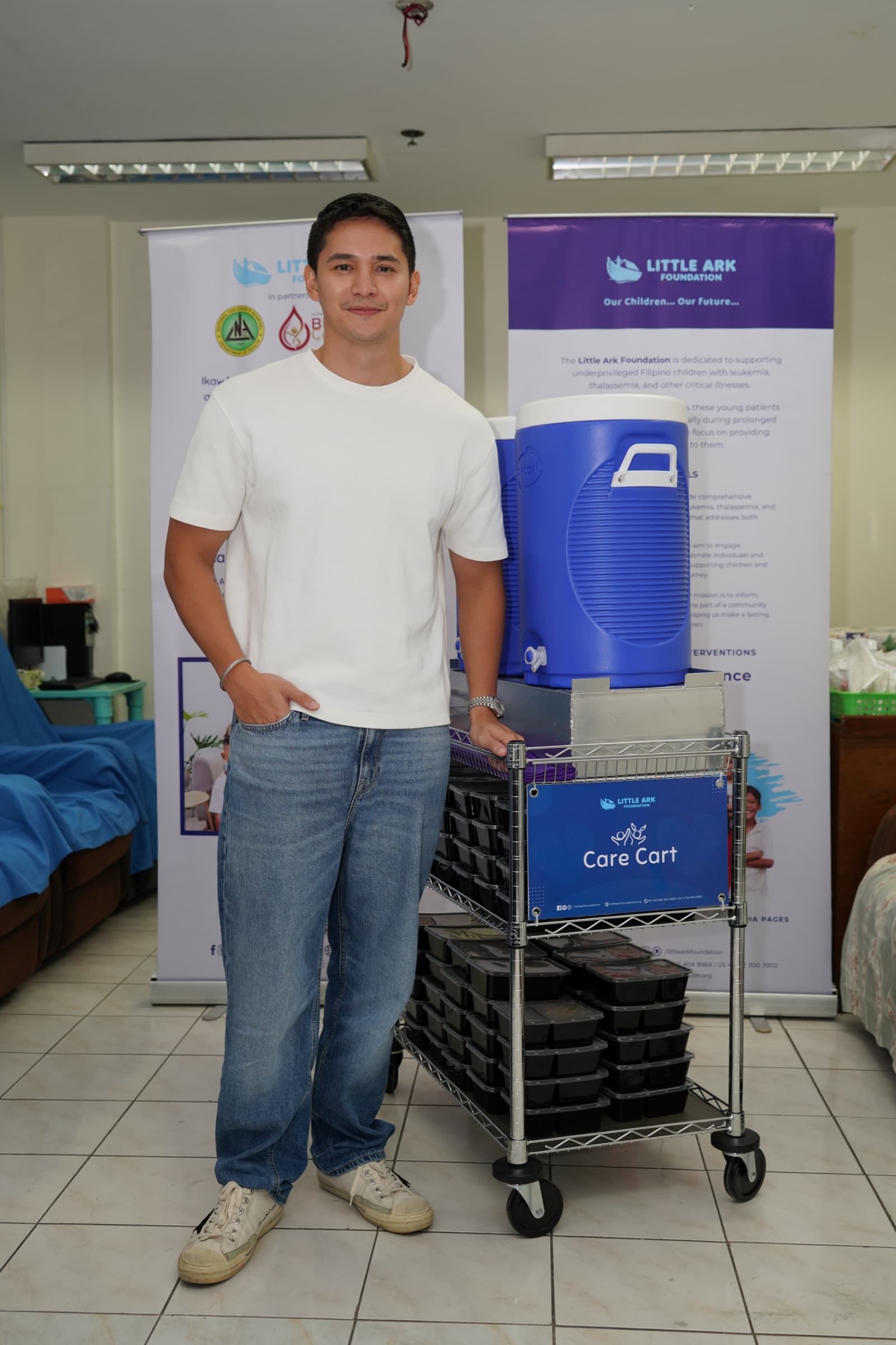 Ruru Madrid standing beside the donated Little Ark Care Cart