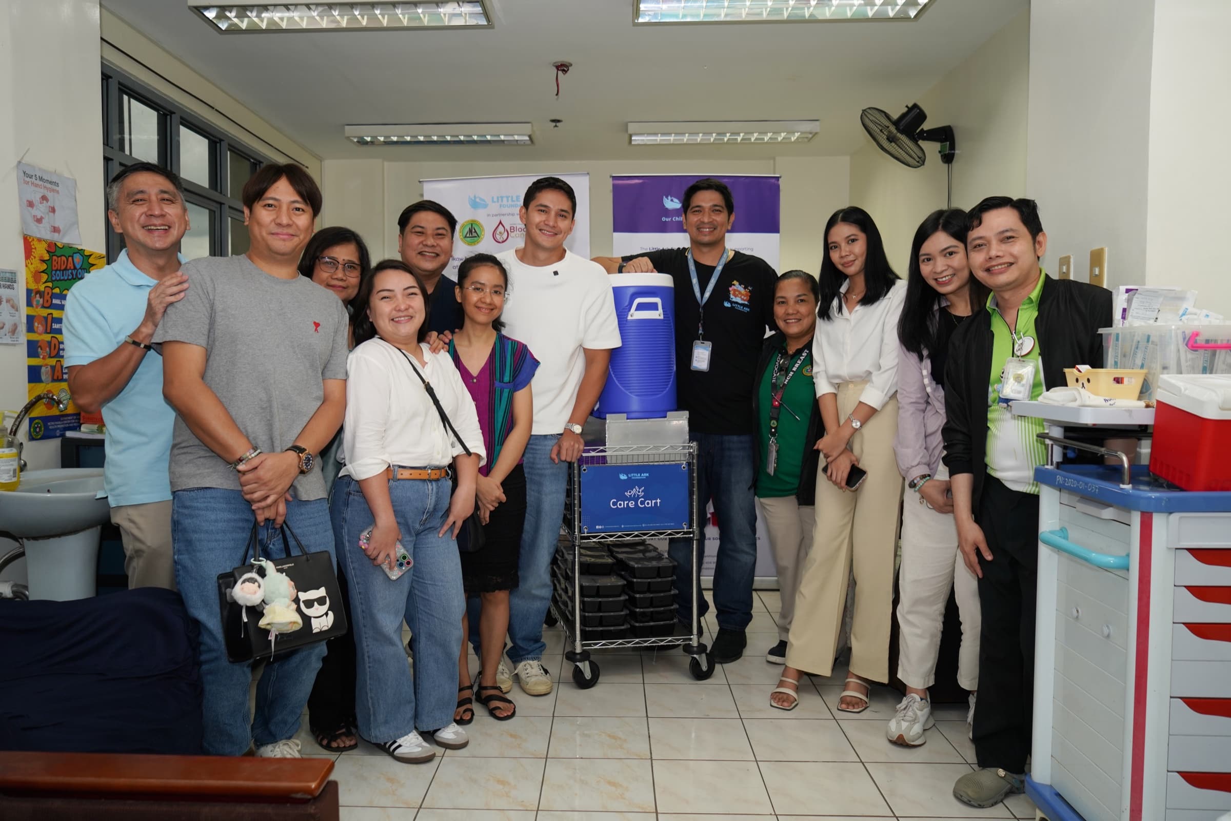 Little Ark Foundation partners gathered with the donated Care Cart