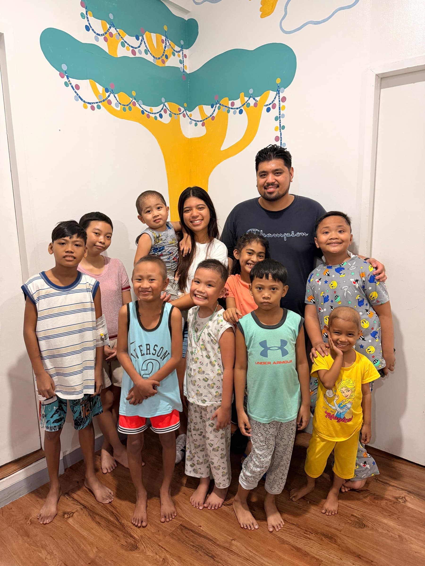 Children and caregivers gathered inside the Little Ark Foundation home