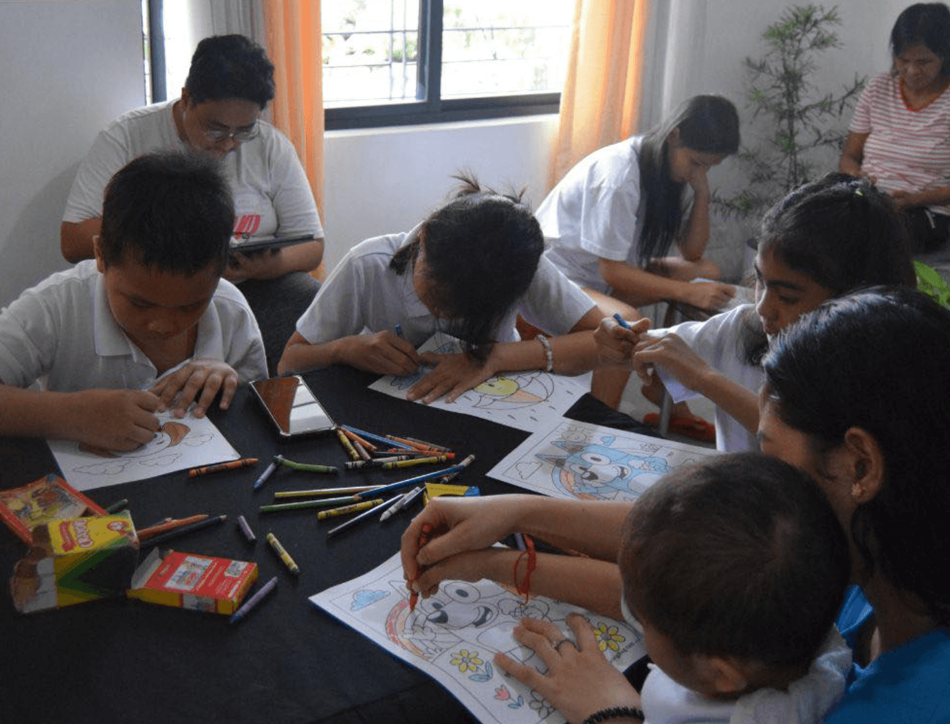 Children coloring together during a Little Ark activity