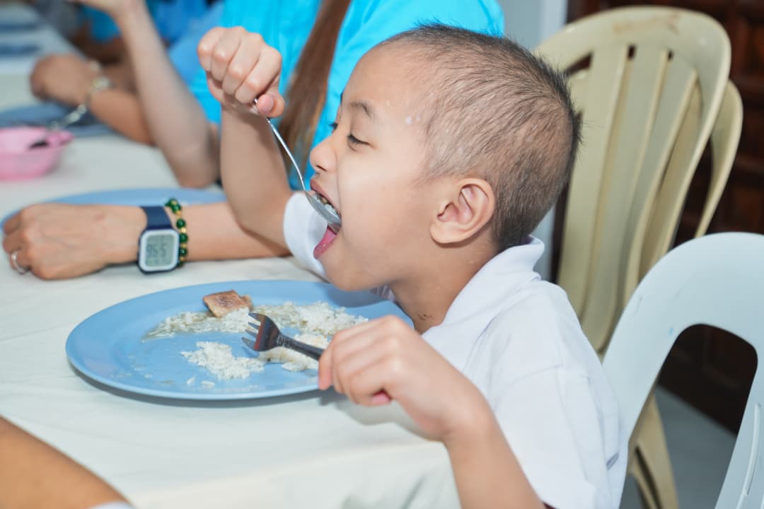 A child eating a meal at Little Ark