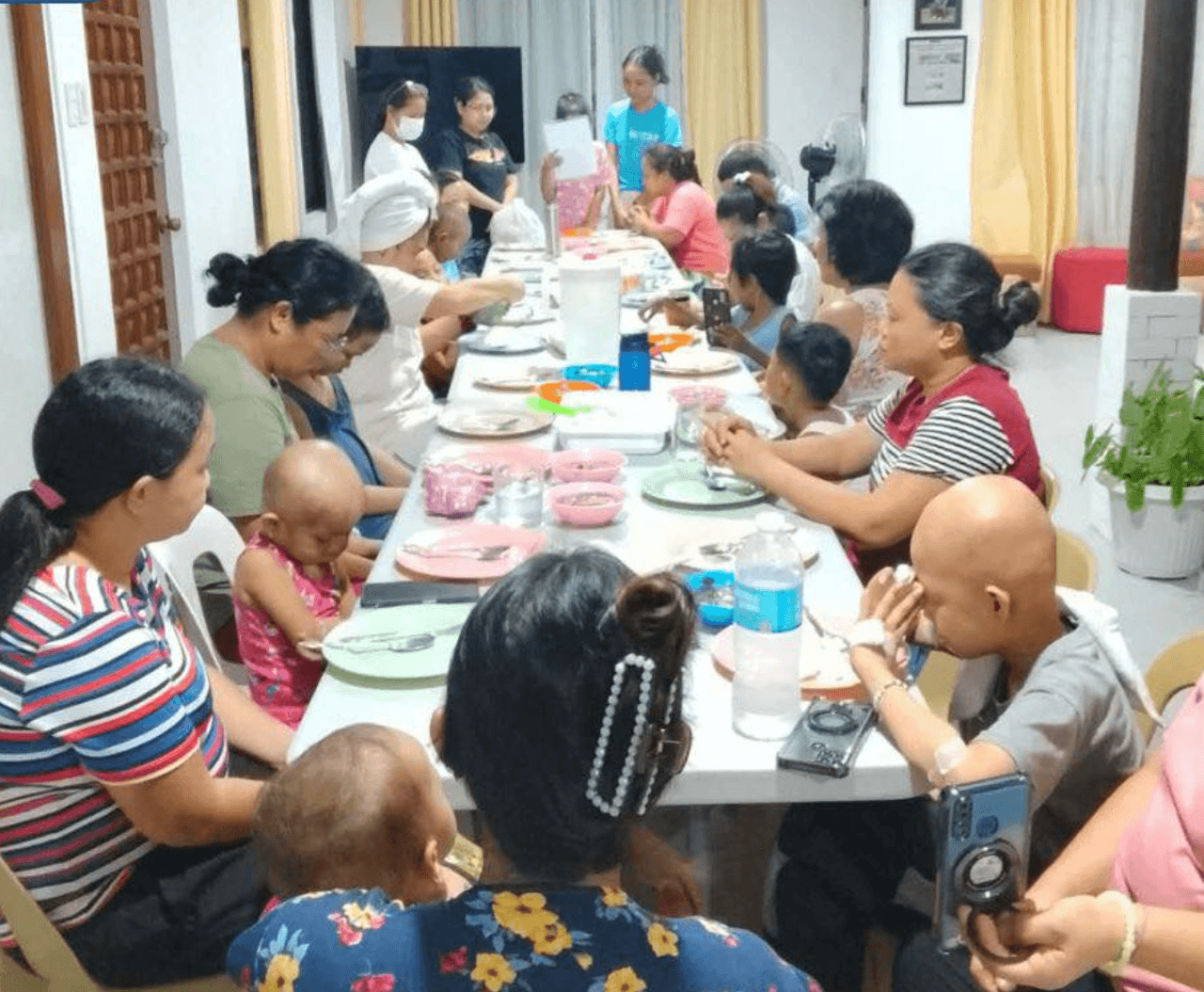 Children and caregivers seated together for an everyday meal