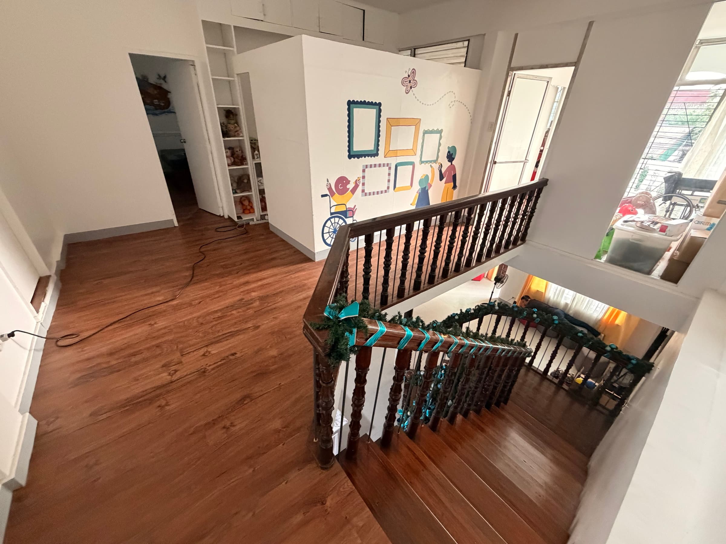 An upstairs hallway and mural inside the Little Ark home