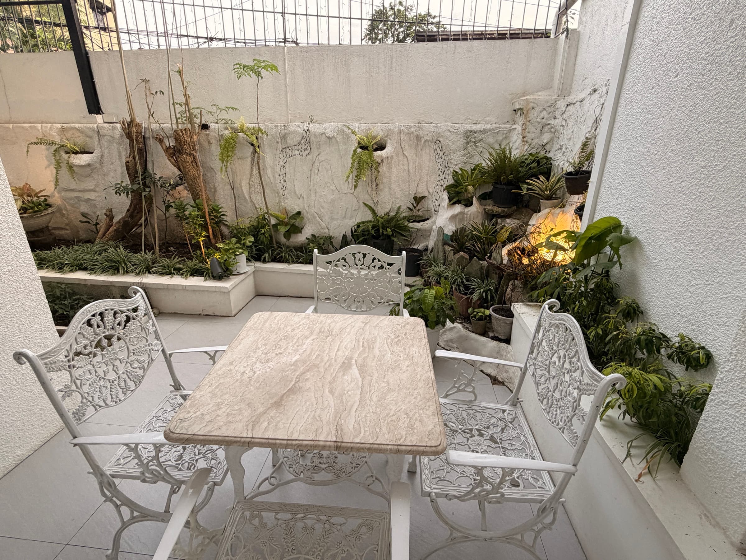 A garden patio with a table and chairs at the Little Ark home