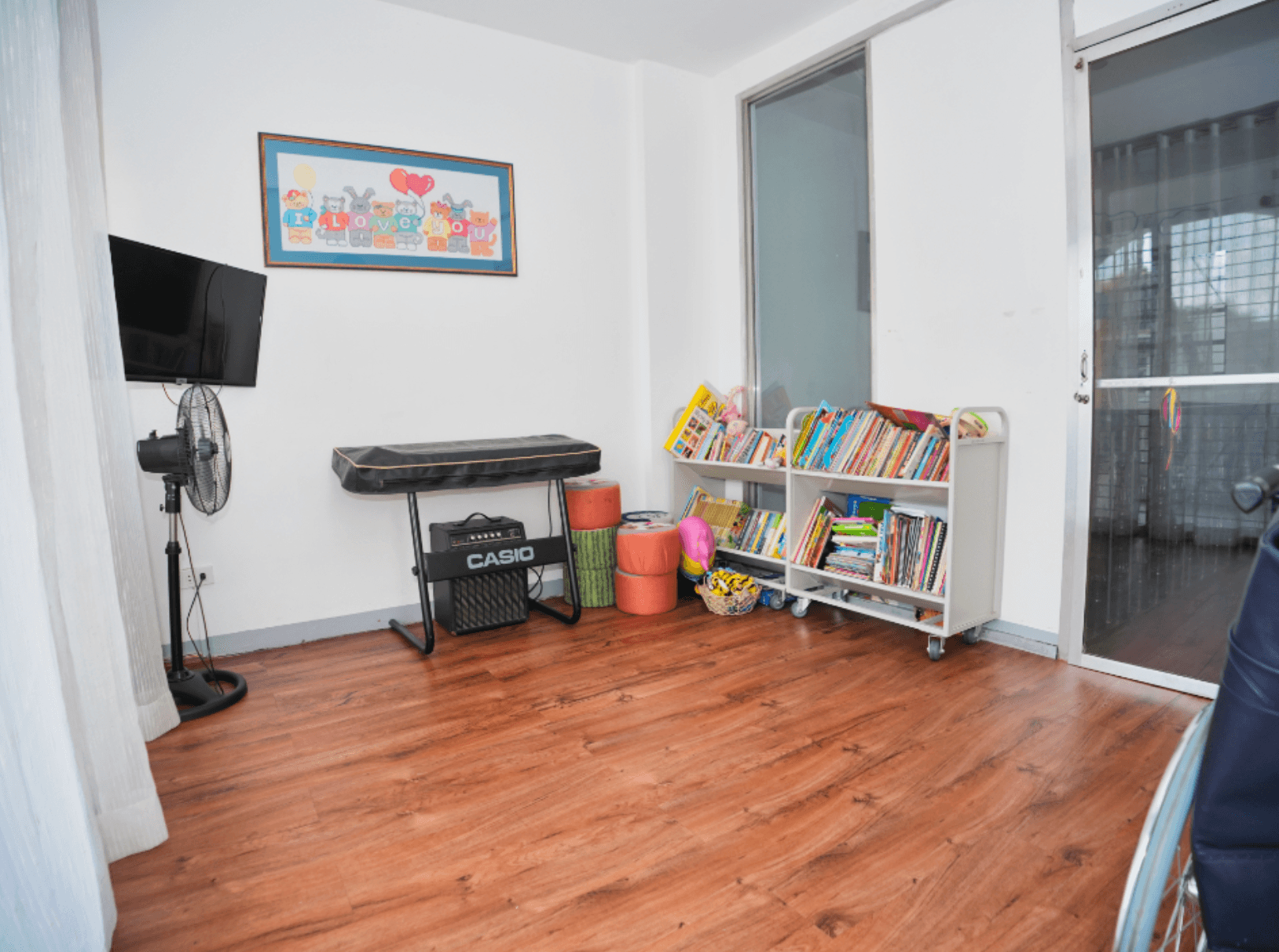 A child-friendly activity room with books and toys inside the Little Ark home