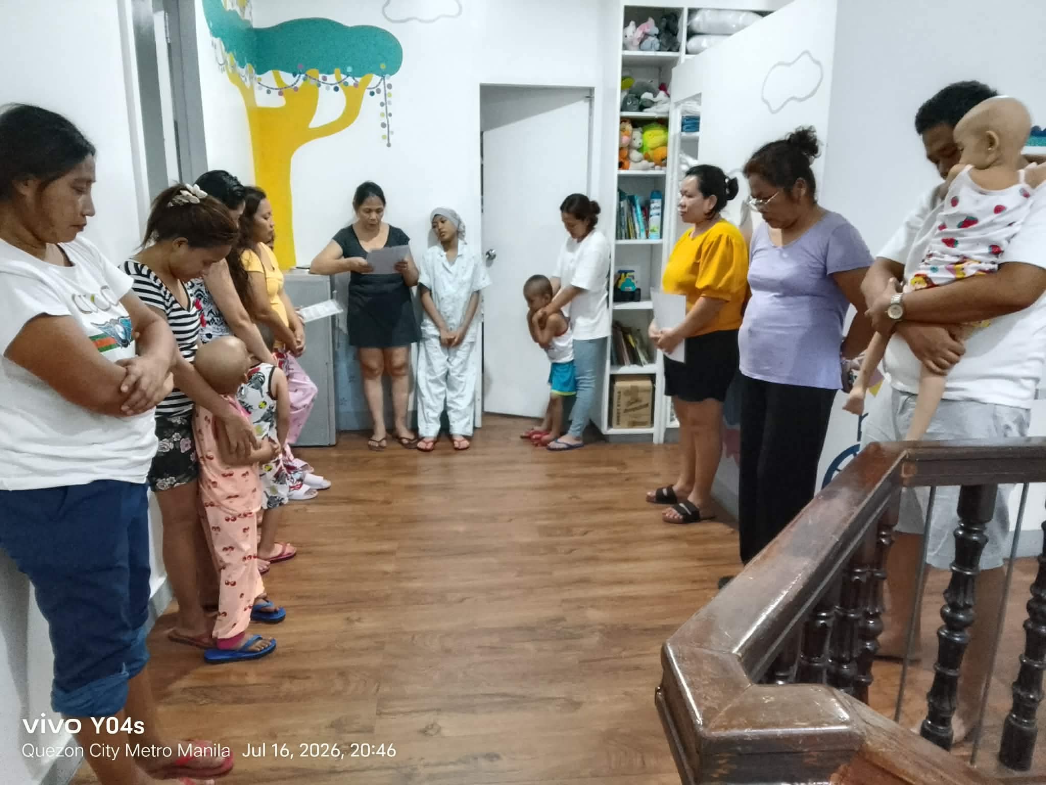 Little Ark families gathered in a prayer circle
