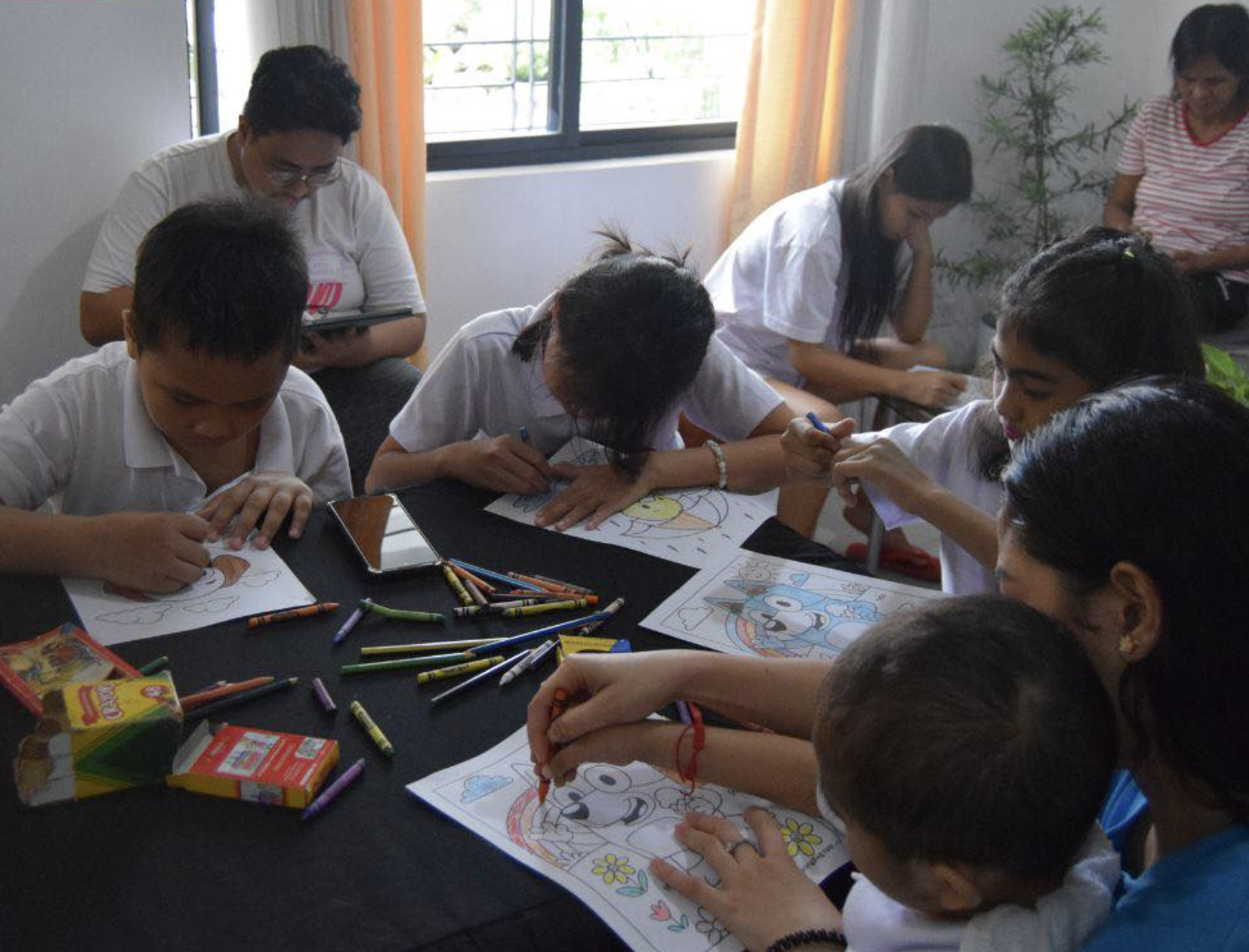 Children coloring together during a Little Ark activity