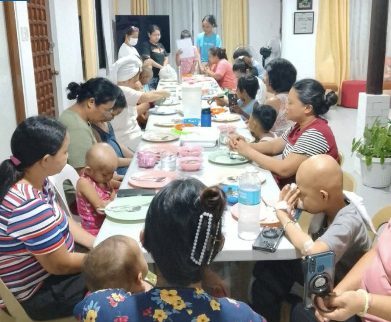 Children and caregivers seated together for an everyday meal