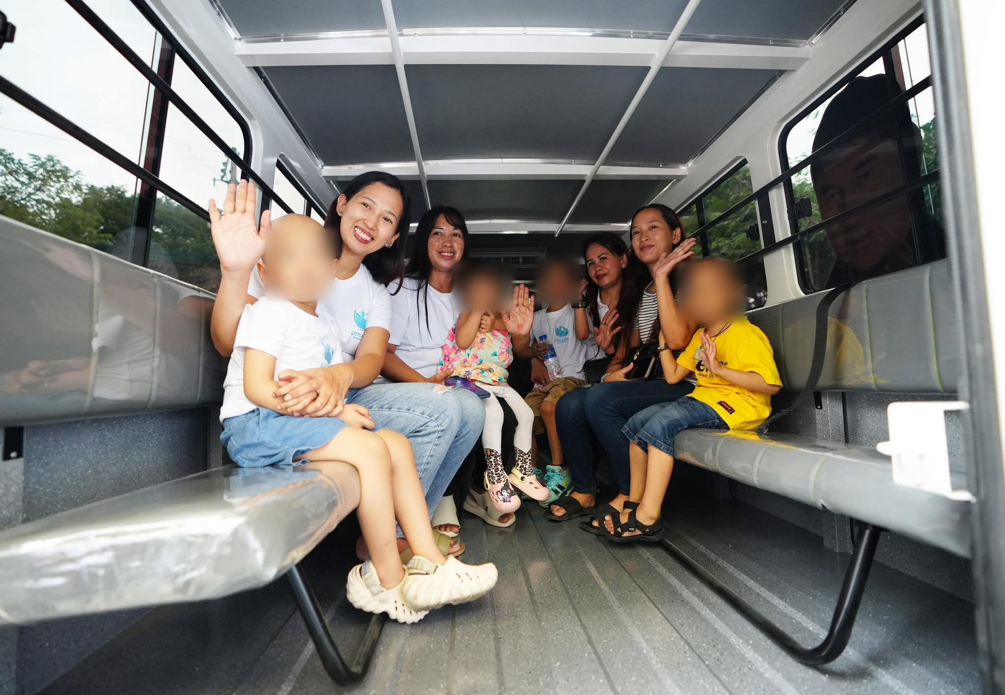 Children, caregivers, and Little Ark team members riding in the Hope in Transit shuttle